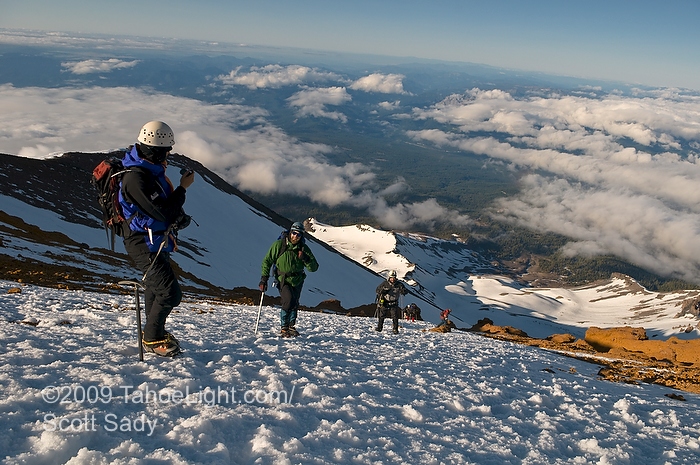 mt_shasta_climb_sunrise_photographs_658 A group of climbers stop to take a self portriat as the sun rises on top of Red Banks on Mt. Shasta's avalanche gulch route.