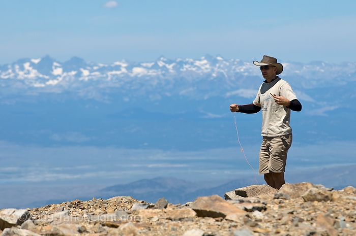 Researcher Jimmy () sets up the grids and starting the species count near the 14,000 foot summit of White Mountain for the first US 5-year resurvey as part of the Global Observation Research Initiative in Alpine Environments or (GLORIA) climate change survey at the first US master-site in the White Mountains. Owens Vally and the high sierra rise in the background.