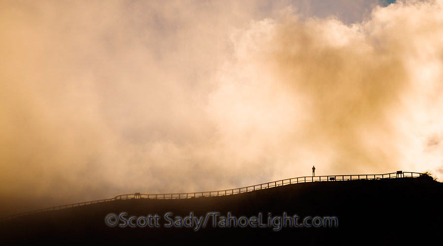 Photographing the cloud bow from the Johnston Ridge observatory at Mt. St. Helens. We found that only by standing on the railing, would the sun hit you and cast a rainbow silhouette onto the clouds. 