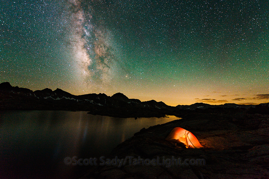 Milky way over tent from a lake in the Dusy Basin in the High Sierra mountain range in California.