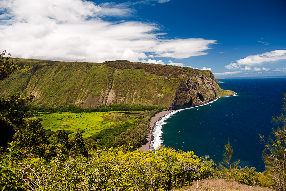The famous Waipi'o Valley on the Big Island of Hawaii. An uber steep, 4 wheel drive only (though it is paved and you could make it with a small car with a good transmission) is the only way in or out. It boasts an awesome black sand beach and a scenic waterfall that was dry when we got there. A hiking trail switches back up the cliff on the far side of this beach into true wilderness.