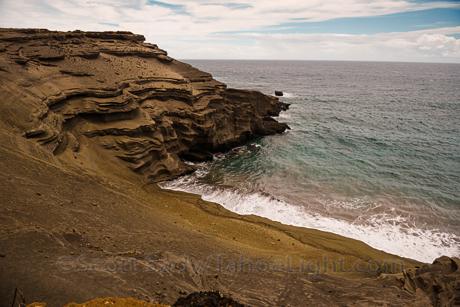 Famous green sand beach near south point on the big island of Hawaii. Before crossing over to dirt roads, there will often be locals offering a $5 "passage" fee to transport you in. If you do not have a high clearance 4x4, and even if you do, but are not an experienced off-roader, PAY THE FEE. I have been driving 4x4's since my dad taught me to drive on sand bars when I was 13 and this was touch and go in good weather. So many deeply rutted tracks constantly diverge and then occasional end in cliffs or holes or other impassible spots. As a general rule, if you drive yourself as we did, stay on the highest tracks.
