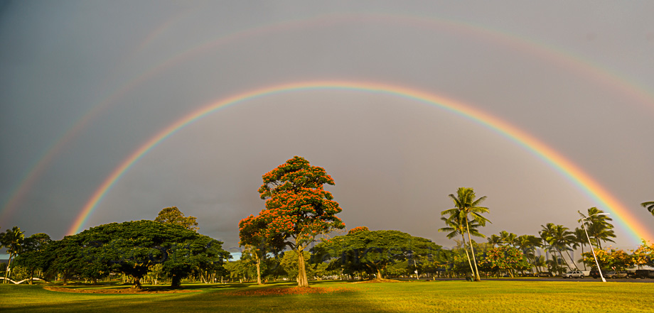 Rainbow over the Japanese gardens in Hilo, where a clock stands stopped at 1:04 am. After a second devastating Tsunami struck here with a 20 foot wave at 1:04 am in 1960, the state prohibited residential rebuilding in the twice affected areas, turning much of the land into public parks.