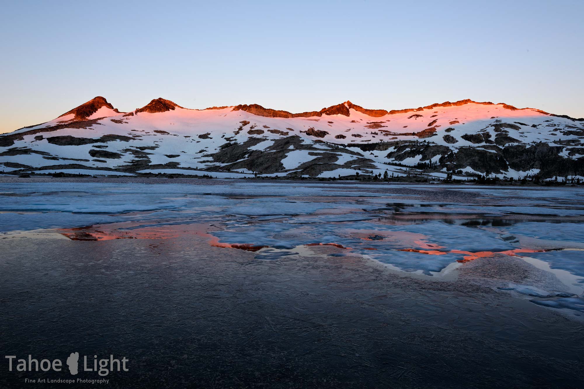 Pink sunrise on snowy mountain