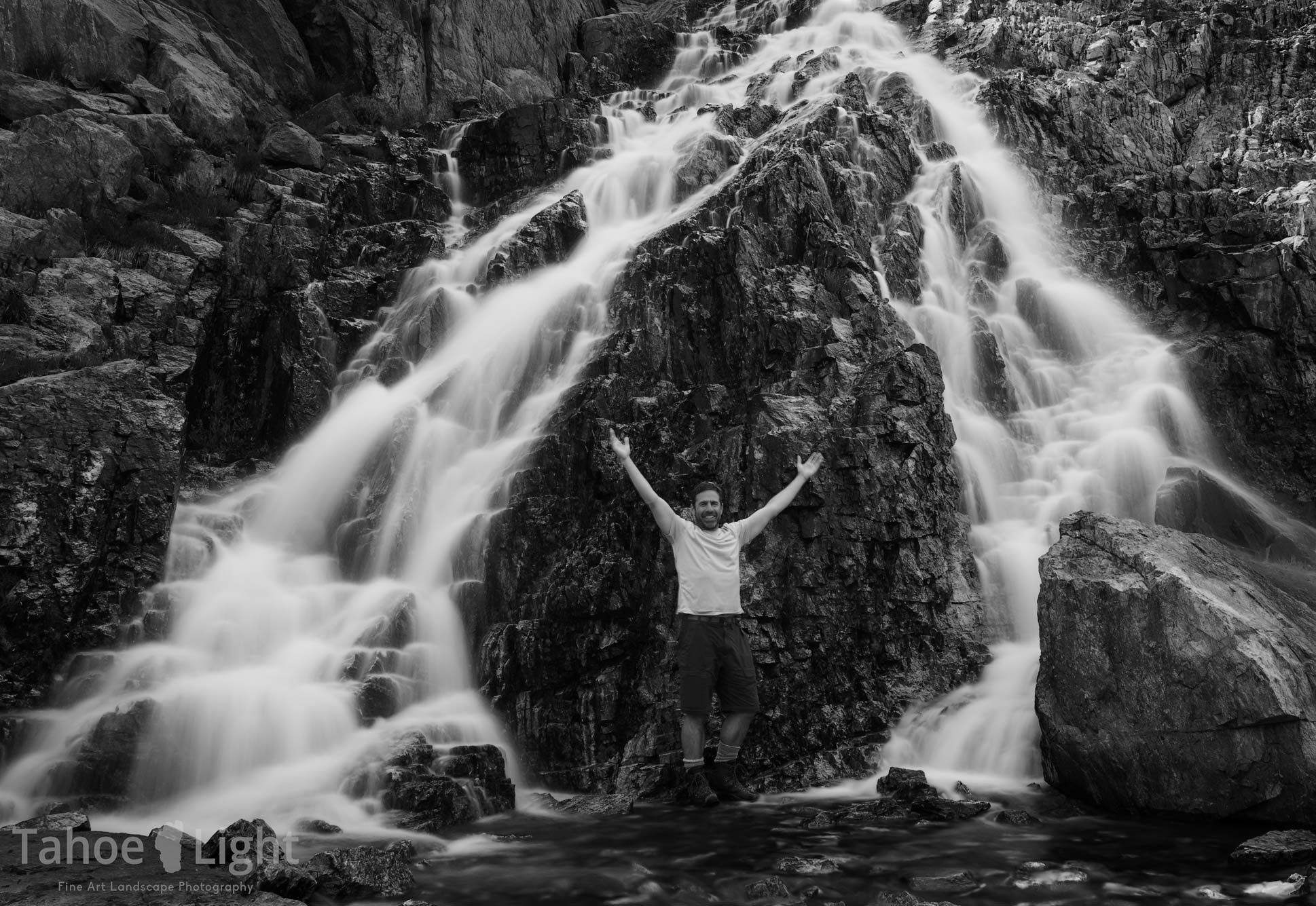 person photographed under waterfall