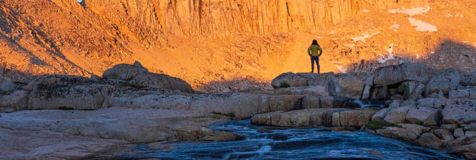 photograph of a woman at sunset looking at the mountains in Bear Lakes Basinhigh sierra