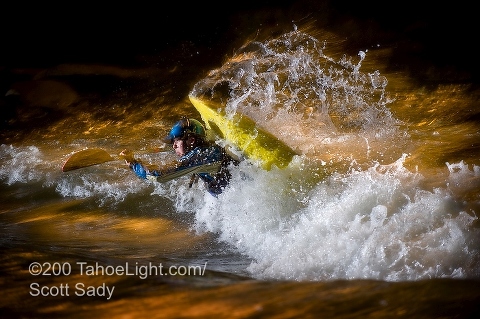 Reno local and top ranked junior kayaker and Jackson team member Jason Craig practices his moves in the Truckee River in downtown Reno, NV at night during the river festival.