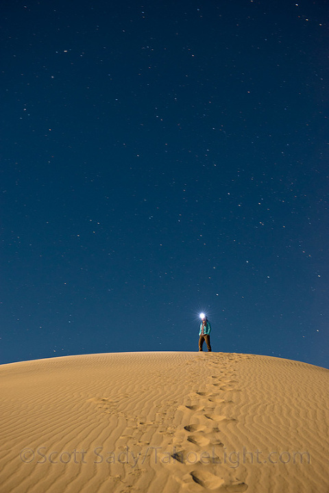 woman on sand dunes at night 
