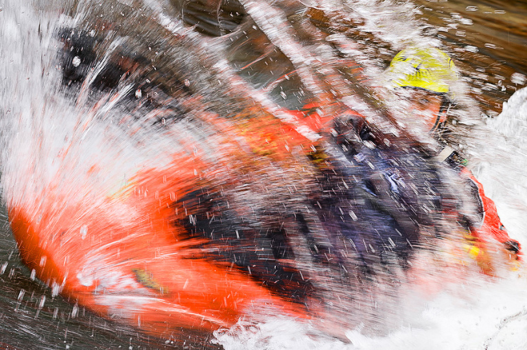 Local kayaking phenom Sage Donnelly behind a curtain of water during her freestyle kayaking competition