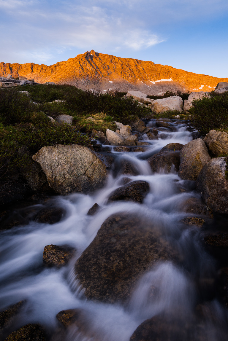 The stream flowing out of Steelhead lake with the last light on the other side of the Four Gables peak.