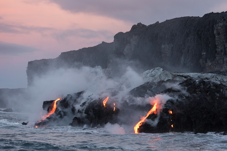 A subtle sunrise at the lava ocean entry seen from the boat.
