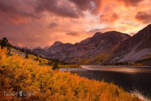 Photograph of fall color and sunset over alpine lake