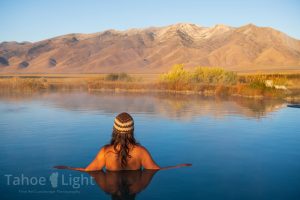 Photograph of woman getting into RUby Valley Hot Spring near Elko