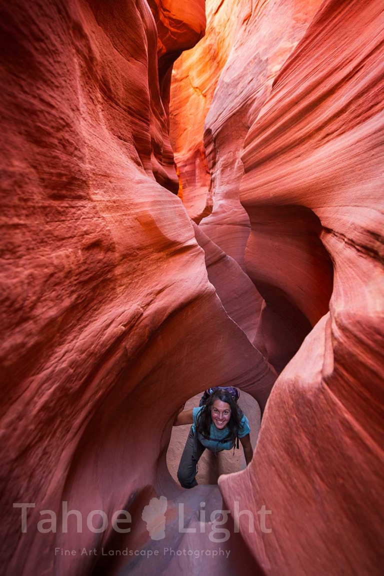 photograph of woman in peek-a-boo slot canyon