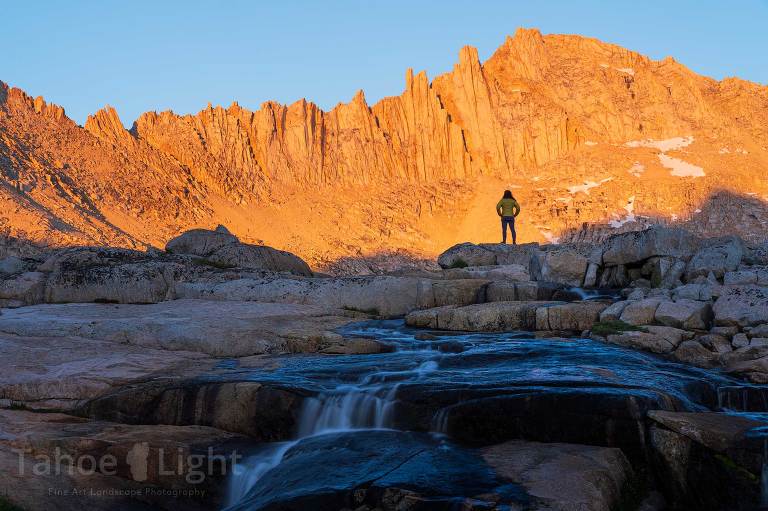 photograph of a woman at sunset looking at the mountains in Bear Lakes Basinhigh sierra